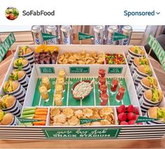 a football party with snacks and snacks on the side, including crackers, dips, and chips