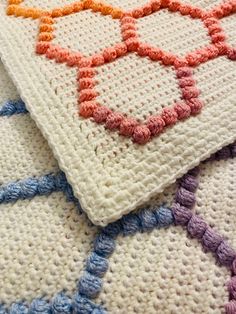 three crocheted rugs on top of each other