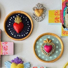 there are many magnets on the wall with different designs and colors in them,