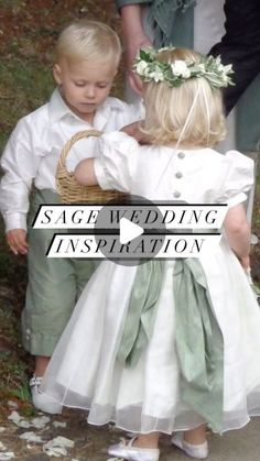 two young children dressed in white and green are standing next to each other with their arms around one another