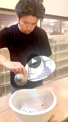 a man pouring something into a white bowl