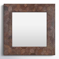 a wooden frame with a square mirror on the wall in front of it and an empty space for text