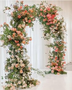 an arch made out of flowers and greenery