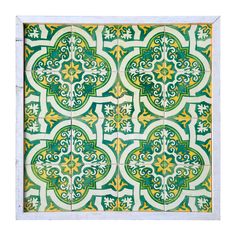 a green and yellow tile pattern on the wall