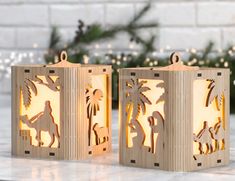 two wooden lanterns sitting on top of a table