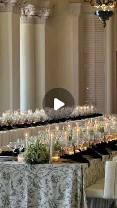 a long table with candles and flowers on it