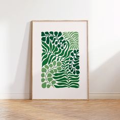 a green leaf print on a white wall in an empty room