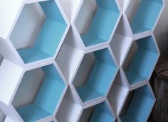 several white and blue hexagonal shelves stacked on top of each other in the same pattern