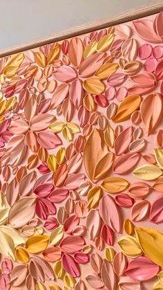 a painting made out of pink and yellow leaves