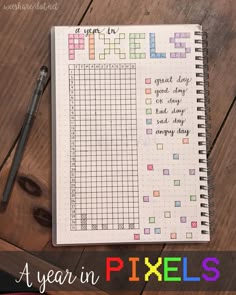 a planner with the words year in pixels on it and a pen next to it