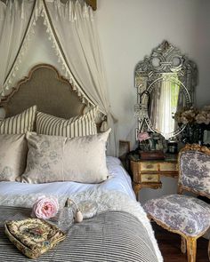 a bed sitting in a bedroom next to a mirror