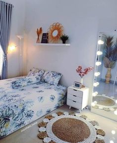 a bed room with a neatly made bed and a mirror