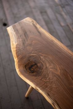 a wooden bench sitting on top of a sidewalk