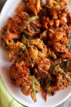 a white plate topped with fried food on top of a table