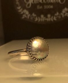 Silver Pearl ring. Grey Pearl Ring. Solitare Pearl Ring. Round Pearl Ring. Modern Pearl Ring. Girlfriend gift. Beautifully Handcrafted upcycled bezel set Natural Cultured Pearl set on a lightly hammered solid sterling silver band.. This unique yet very versatile ring is a size 9 1/2 but is available in any size with a very similar Pearl and is sure to be your go to accessory for all your fresh spring looks. ❤️❤️Give the thoughtful gift of handcrafted. ❤️❤️ Great bridesmaid gift! Will dis... Unique Sterling Silver Pearl Promise Ring, Unique Pearl Promise Ring, Silver Pearl Ring With Cabochon, Unique Gemstone Dome Ring, Heirloom Pearl Ring With Birthstone, Heirloom Pearl Birthstone Ring, Iridescent Birthstone Rings For Gift, Adjustable Pearl Promise Ring With Round Band, Adjustable Pearl Promise Ring