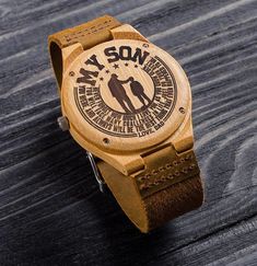 a wooden watch with the words my son written on it's face and an image of two people holding hands