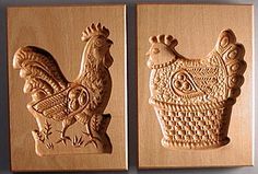 two wooden plaques depicting roosters and chickens