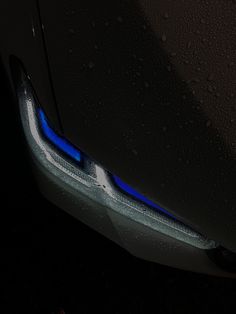 the front end of a car with blue lights