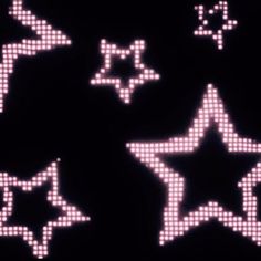 several white stars are shown on a black background with pink lights in the shape of dots