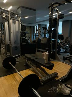 an empty gym with equipment in the foreground