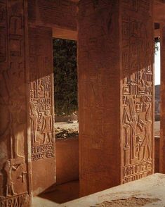 an egyptian style room with carvings on the walls