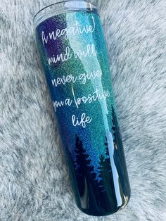 a blue and green tumbler with the words, negative minds never give up a positive life