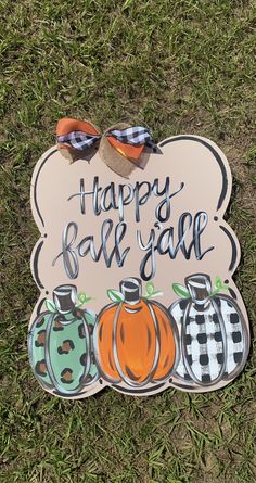 a sign that says happy fall gar with pumpkins and checkered bows on it