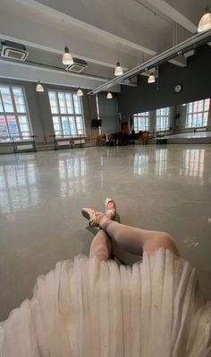 a woman laying on the floor in a large room