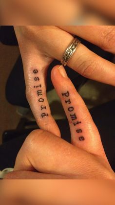 two fingers that have tattoos on them with the words brothers and sisters written on them