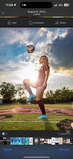 a woman kicking a soccer ball on top of a green field with the sun behind her