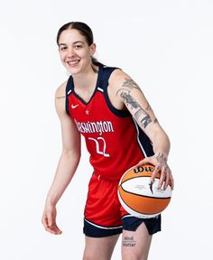 a woman holding a basketball in her right hand