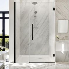 a bathroom with marble walls and flooring, including a walk - in shower stall