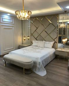 a bedroom with a large bed and chandelier