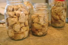 three jars filled with food sitting on top of a table