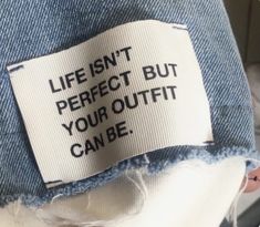 a label on the back of a jean jacket that says, life isn't perfect but your outfit can be