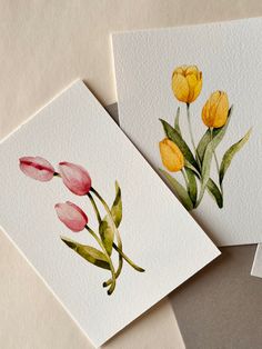 two watercolor paintings of flowers on white paper next to each other, one with yellow and pink tulips