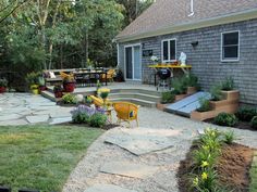 an outdoor patio with steps leading up to the deck and seating area, surrounded by landscaping