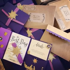 purple and gold wedding stationery with matching envelopes, cards, and other items