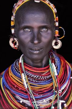 an african woman with large earrings on her head