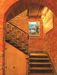 an arched doorway with stairs leading up to the second floor