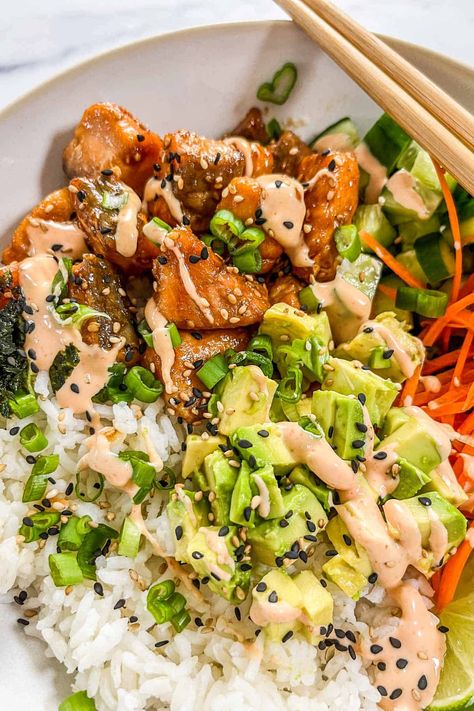 You'll love the flavor in these crispy salmon bowls with rice! They have the perfect balance of lightly crispy but still tender salmon bites paired with fresh veggies, sushi rice, a little bit of nori, and spicy mayo. This is a meal the whole family will love! Firecracker Salmon Bowl, Sticky Miso Salmon Bowl, Salmon Rice Bowl Air Fryer, Crispy Salmon Bowl, Salmon Sushi Bowl Recipe, Salmon Bowl Recipe, Salmon Sushi Bowl, Spicy Mayo Recipe, Salmon Poke Bowl