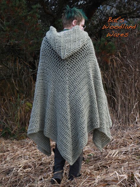 This sage green hooded cloak features a short hood and a metal clasp. The cloak comes to three large points around the bottom. My hooded cloaks are perfect for keeping you warm and snug during the autumn and winter months. Color: Sage Green Materials: Yarn (wool, acrylic), metal clasp Size: One-size-fits-most Hood Length (front to point): 13 inches (33 cm) Hood Height (neck to top of hood): 17 inches (43 cm) Neck Circumference (excluding clasp): 24 inches (61 cm) Cloak Length (from neck to lowes Crochet Cloak Pattern, Crochet Poncho With Hood, Crochet Cloak Pattern Free, Crochet Hooded Cloak, Crochet Cloak With Hood, Winter Crochet Clothes, Crochet Winter Ideas, Crochet Hooded Cape, Knit Cloak