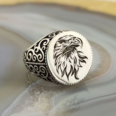 The ring is made of 925 sterling silver and decorated with eagle head embroidery. PRODUCT FEATURES -Products are shipped with free express shipping with box and bag. - Crafting Material : 925K Sterling Silver - Weight : 14.0 grams - Ring Diameter : 18 mm - Gender : Male / Female Eagle Rings For Men, Ring Without Stone, Engraved Silver Ring, Embroidery Product, Gents Ring, Eagle Ring, Mens Gold Jewelry, Eagle Design, Pattern Ring