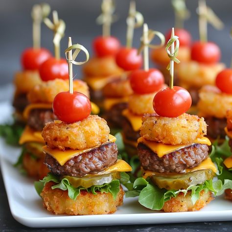 🍔🧀 Bite-sized Mini Tater Tot Cheeseburgers that are sure to be a hit! #PartyFood #Cheeseburger Mini Tater Tot Cheeseburgers Ingredients: Ground beef (1 lb) Salt and pepper (to taste) Cheddar cheese (4 slices, quartered) Tater tots (24, cooked) Lettuce (1/2 cup, shredded) Pickles (12 slices) Cherry tomatoes (6, halved) Toothpicks Instructions: Form ground beef into small patties, season with salt and pepper. Cook patties in a skillet until browned. Top each patty with a cheese quarter. Ass... Mini Bunless Cheeseburger Bites, Individually Wrapped Party Food, Cheeseburger Birthday Party, Meat Cupcakes, Tater Tot Appetizers, Gender Reveal Food, Friendship Crafts, One Bite Appetizers, Burger Bites