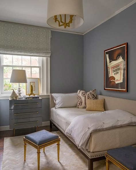 Blue lacquer nightstand against a bedroom window fitted with a Roman shade beside a twin corner bed dressed with tan bedding and a frame with nailhead trim. Blue Guest Bedroom, Bed Against Window, Corner Twin Beds, Bed Against Wall, Pale Blue Bedrooms, Liz Caan, Boys Bedroom Green, Tan Bedding, Guest Bedroom Inspiration