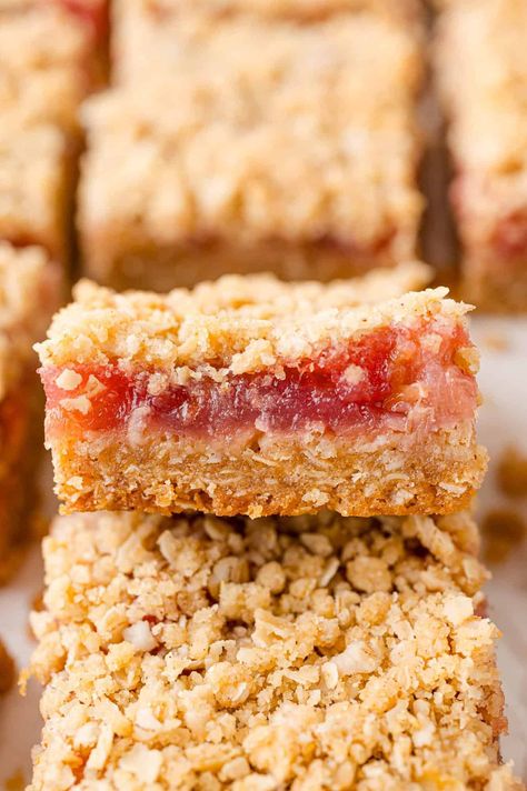 Rhubarb bars are the perfect treat for when rhubarb’s in season and you don’t want to fuss with making a whole pie! Tart rhubarb is balanced by sweet strawberry preserves, then baked until jammy with cinnamon-spiced oat crust. Rhubarb Crumble Bars, Rhubarb Bars Recipes, Rhubarb Squares, Strawberry Rhubarb Bars, Almond Paste Recipes, Oat Crust, Rhubarb Bars, Blueberry Crumble Bars, Crumb Bars