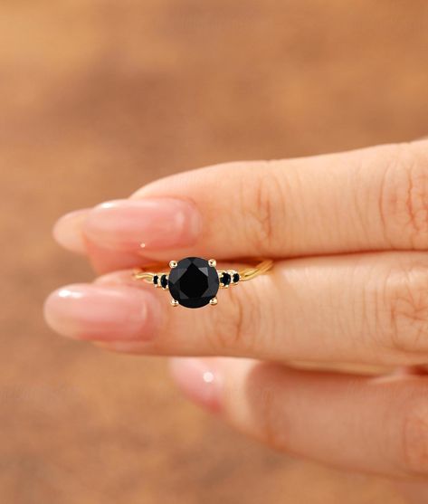 Other Gemstones: Black Rutilated Quartz: https://www.etsy.com/listing/1848416672/ Moss Agate: https://www.etsy.com/listing/1884673947/ Ring Features ♡ Made to Order ♡ Material Options: 925 Sterling Silver (Yellow, Rose or White Gold Plated), Solid 10K/14K/18K Gold ♡ Gold Color Options: Rose Gold, Yellow Gold, White Gold ♡ Center Stone: Round Cut Natural Black Onyx ♡ Center Carat Weight: 1.25CT(approx 7mm) ♡ Side Stones: Round Black Onyx(1.5mm/2mm-2pcs) & Round Moissanite- approx 0.14ctw ♡ Band W Black Stone Engagement Ring, Black Stone Ring Engagement, Gold Onyx Ring, Ring Black Stone, Black Rutilated Quartz, Gold Items, Silver Items, Engagement Ring For Women, Statement Ring Silver