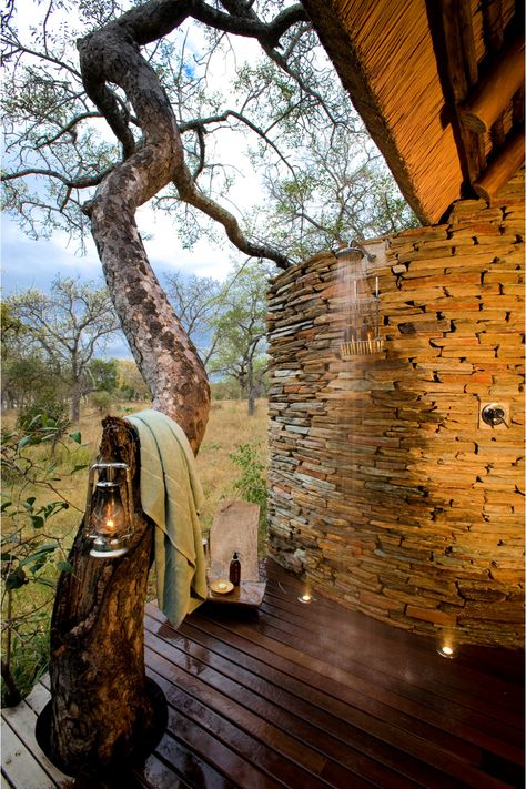 Outdoor shower on wooden deck with large tree as towel rack. Rough Hewn Wood, Luxury Safari Lodge, African Landscape, Outdoor Tub, Game Lodge, Luxury Safari, Unique Shower, Luxury Lodge, Safari Lodge