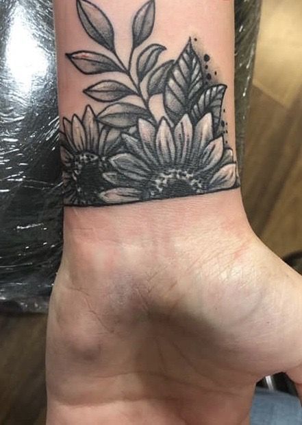 Boho Cover Up Tattoo, Flower Wrist Tattoos For Women Cover Up, Small Wrist Tattoos Cover Up, Sunflower Wrist Tattoo Coverup, Black Flower Wrist Tattoo, Flower Cover Up Tattoo Wrist, Coverup Shoulder Tattoos For Women, Side Of Wrist Tattoo Coverup, Large Ankle Tattoo Cover Up