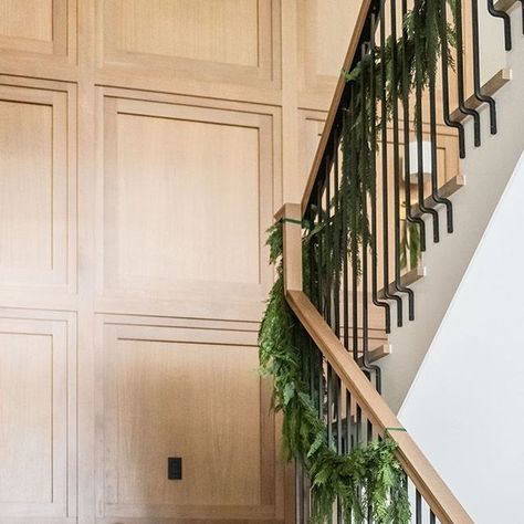 Remedy Design Firm on Instagram: "This white oak accent wall is so beautiful as is. As we styled the holiday decor in this stairway, we wanted the beauty in the details of this home to still be present, so we selected simple greenery and ribbon to deck the halls of our #maplecrossingsproject. Furniture & Accessories: @elementsbyremedy Builder: @rcdentcustomhomes Architect: @jewkeshomedesign Photography: @rebekahwestoverphotography Design: @remedydesignfirm #maplecrossingsproject #remedydesignfirm #elementsbyremedy #utahhomes #homedesign #homeinspiration #homeinspo #housedesigns #homeinteriordesign #interiordesign #interiordesigninspiration" White Oak Wood Paneling, Stairs With Paneling, Wood Panel Staircase, White Oak Wainscoting, Staircase Wood Paneling, White Oak Paneling Walls, Stairwell Molding Ideas, Stairway Trim Ideas, White Oak Accent Wall